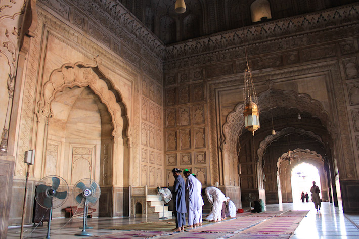 People praying in the prayer hall of badshahi mosque lahore